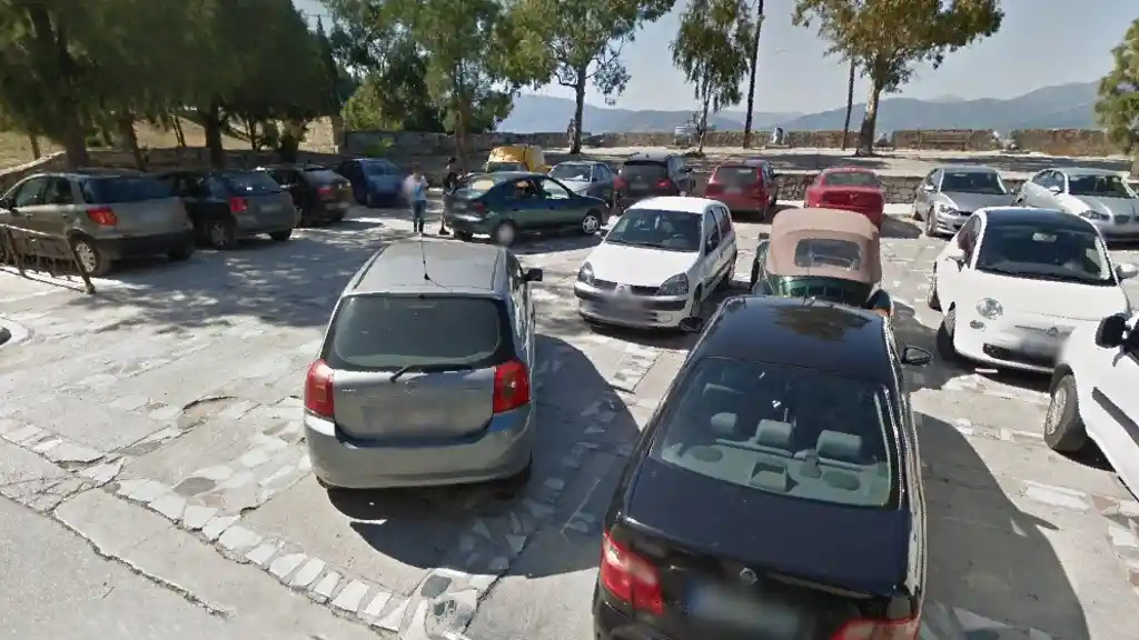 Free parking area at Nafplio harbor, cars and boats