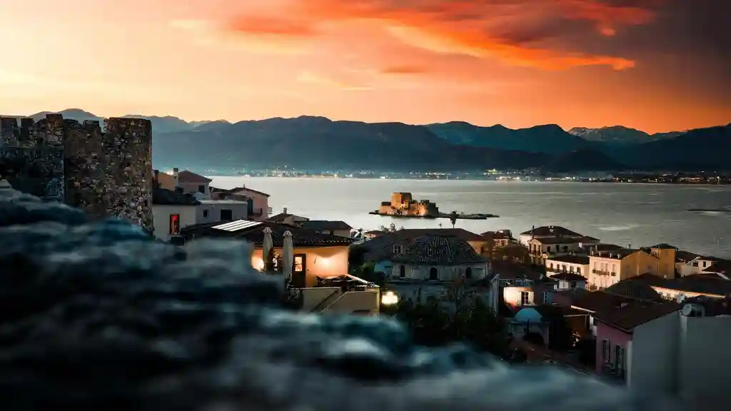 Romantic golden hour over Nafplio old town with Bourtzi fortress and the sea during sunset